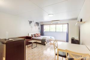 a living room with a couch and a table at Popular Condo C5 IMPACT in Pak Kret