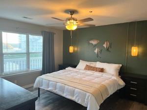 a bedroom with a bed and a ceiling fan at Condo at Parkview Bay - Your Lakefront Oasis in Osage Beach