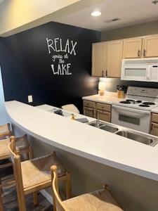 a kitchen with a white counter and a black wall at Condo at Parkview Bay - Your Lakefront Oasis in Osage Beach