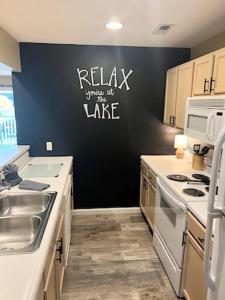 a kitchen with a sink and a black wall at Condo at Parkview Bay - Your Lakefront Oasis in Osage Beach