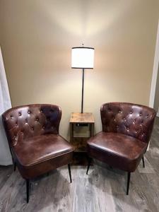 two leather chairs and a lamp in a room at Condo at Parkview Bay - Your Lakefront Oasis in Osage Beach