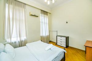 - une chambre avec 2 lits, une commode et une télévision dans l'établissement SAHIL PARK 2 Bedrooms, à Baku