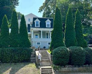 a house with a bunch of trees in front of it at Modern Studio in Norwalk in Norwalk