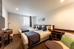 Letto o letti in una camera di HOTEL MYSTAYS Kanazawa Castle