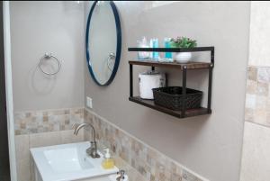 a bathroom with a sink and a mirror at Comfi Spaces in Canaan