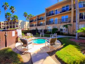 a apartment complex with a small pool in front of a building at Surfside I 310 Condominium Condo in South Padre Island