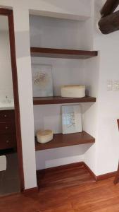 a room with shelves with two cakes on them at Hermoso y cómodo Departamento a pasos de la plaza in Tarija