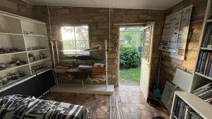 a room with a book shelf and a window at Instituto Bugio Ruivo in Eldorado do Sul 