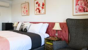 a hotel room with a bed and a chair at Daylesford Art Motel in Daylesford