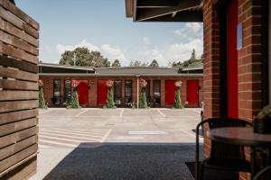 a courtyard of a building with christmas trees at Daylesford Art Motel in Daylesford