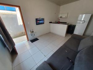 a living room with a couch and a refrigerator at Ingá Hospedagem in Porto Velho