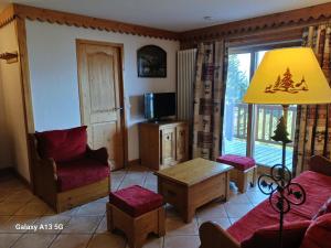 a living room with a couch and chairs and a television at Appartement Les Arcs 1800, 4 pièces, 8 personnes - FR-1-411-909 in Bourg-Saint-Maurice