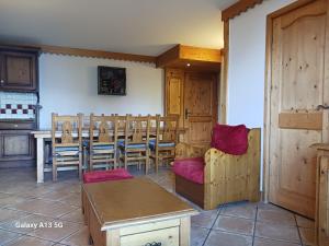 a dining room with a table and chairs in a room at Appartement Les Arcs 1800, 4 pièces, 8 personnes - FR-1-411-909 in Bourg-Saint-Maurice