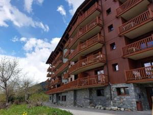 a red building with balconies on the side of it at Appartement Les Arcs 1800, 4 pièces, 8 personnes - FR-1-411-909 in Bourg-Saint-Maurice