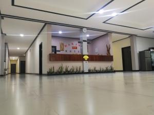 a large empty room with a lobby with a counter at Marina Hotel 