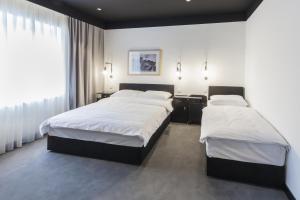 Voodi või voodid majutusasutuse The Loop Hotel toas