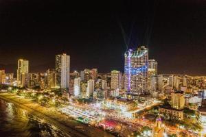 a city lit up at night with many tall buildings at Panorama Sky Blue Nha Trang in Nha Trang