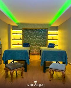 two beds in a room with green lights at A Diamond The Resort Spa Sapanca in Sapanca