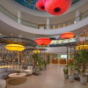 a lobby with red lanterns and potted plants at Occidental Eden Beruwala in Bentota