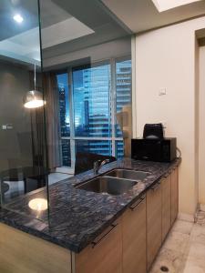a kitchen with a sink and a view of the city at Apartement The Peak Sudirman in Jakarta