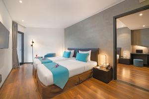Łóżko lub łóżka w pokoju w obiekcie The Code Hotel & Spa Da Nang