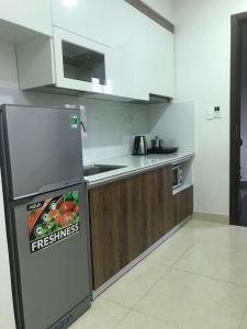 a kitchen with a refrigerator and a counter top at SHILLA HOTEL in Hai Phong