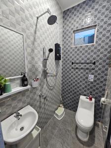 a bathroom with a shower and a toilet and a sink at Glamstay BatuRakit by Beach (Netflix,Umt,Unisza,Ipg) in Kuala Terengganu