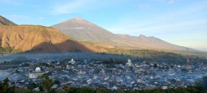a view of a city with mountains in the background at Bengker Bungalow in Sembalun Lawang +5 photos