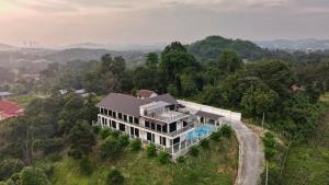 an aerial view of a house with a swimming pool at Jenderam Hill Villa in Sepang