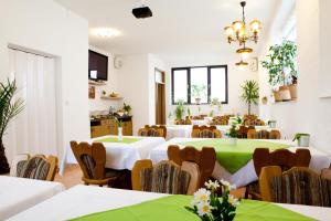 a large room with tables and chairs with green table cloth at Hotel Kreuz in Schwäbisch Gmünd