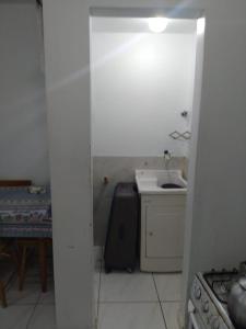 a small kitchen with a sink and a stove at AP beira mar perto do centro in Capão da Canoa