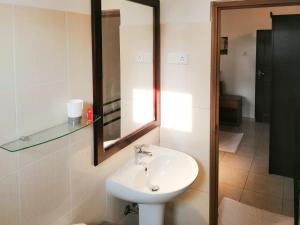 een badkamer met een wastafel en een spiegel bij Villa One64 Beach Front Ground Floor 2BR Apartment in Hikkaduwa
