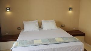 Voodi või voodid majutusasutuse Lombok Coconut Hotel toas
