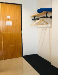 a wooden door in a room with a black rug at At Bangkok Hotel in Bangkok