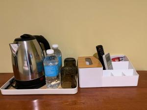 a coffee maker and a tea kettle on a table at Rahmah Sojourn Center in Johor Bahru