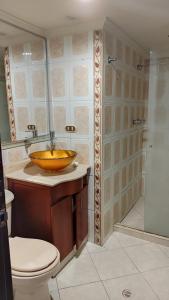 a bathroom with a wooden sink and a shower at Habitación sencilla y central #6 in Medellín