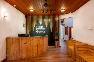 a lobby of a restaurant with a wooden wall at Gentz Residency & Restaurant in Colombo