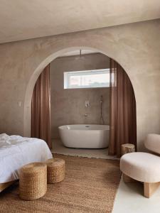 1 dormitorio con 1 cama y bañera en una habitación en AMBERGRIS en Liên Trì (3)