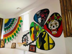 a wall mural of a butterfly with skulls at Little Folly in Ella