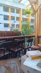a restaurant with tables and chairs and a building at Hsinchu Book&Bed in Hsinchu City