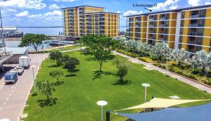 a large grassy area with trees and buildings at Cute & Cosy Darwin Waterfront Apartment with Queen Bed in Darwin