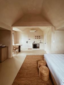 a bedroom with a bed and a table and a kitchen at AMBERGRIS in Liên Trì (3)