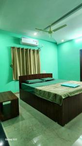 a bedroom with two beds in a room at RUSHITHA HOME STAY-AC Rooms-FREE WIFI-FLAT TV- KITCHEN-DOOR SERVICE-NEAR TO ALIPIRI in Tirupati