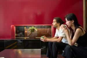 a man and a woman sitting next to each other at Hotel Resol Trinity Kanazawa in Kanazawa