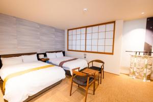 Postel nebo postele na pokoji v ubytování Hotel Rakurakuan