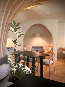 a dining room with a table and a stone wall at Garden Retreat in Bran