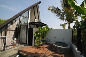 a house with a hot tub on a patio at Ubu Villa Coconut 102 - in Yogyakarta in Yogyakarta