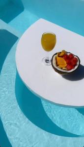a plate of fruit and a glass of juice on a table at Pawikan Seaview Villa with breakfast in Moalboal