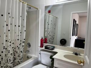 a bathroom with a toilet and a sink and a shower at Hidden valley treehouse home! in Calgary