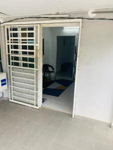 a room with an open door to a room with a table at Simple2 Guesthouse in Pantai Cenang